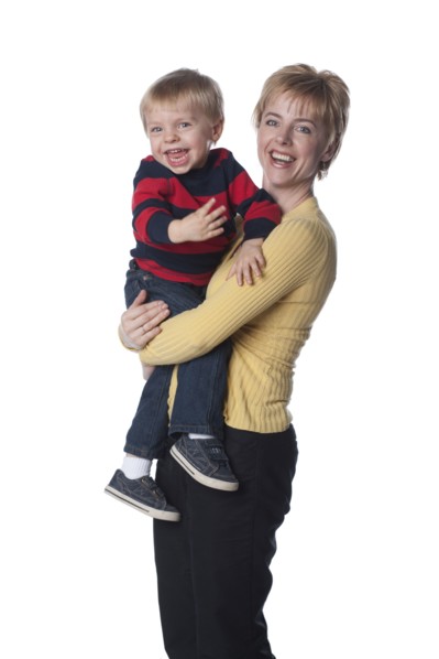 Caucasian mother holding son