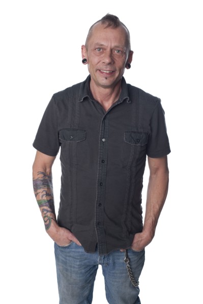 Tattooed Caucasian man with hands in pockets
