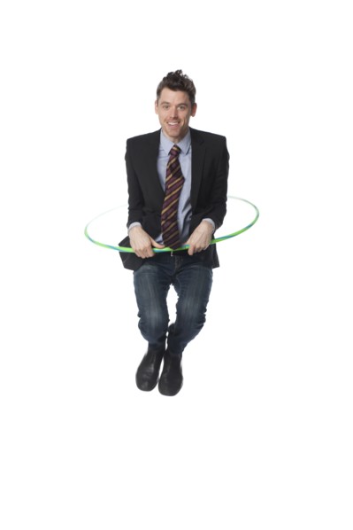 Caucasian businessman jumping plastic hoop