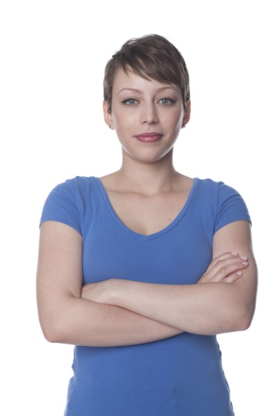 Smiling Hispanic woman with arms crossed