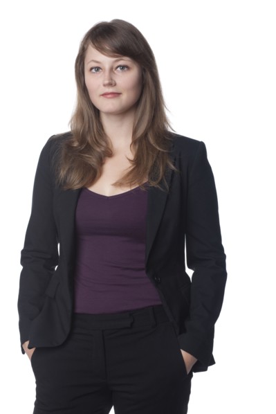 Serious businesswoman with hands in pockets