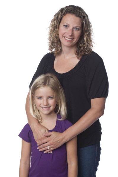 Caucasian mother hugging daughter