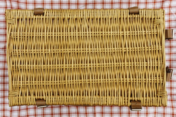 Overhead view of closed wicker picnic basket
