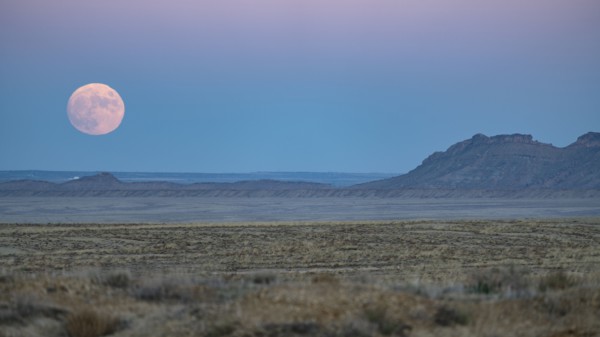 Full moon rising over Navajo Nation desert landscape