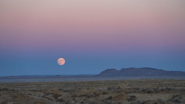 Full moon rising over Navajo Nation desert landscape