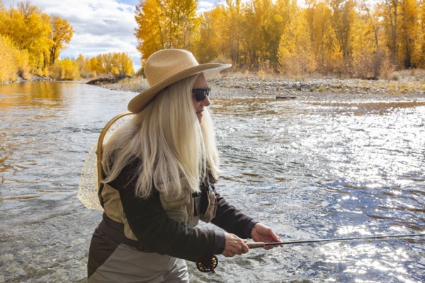 Senior woman fly-fishing