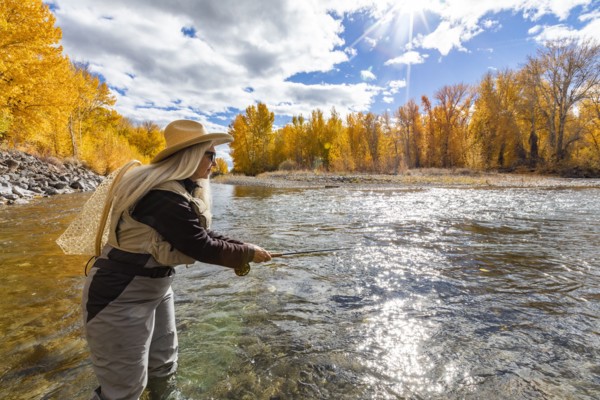 Senior woman fly-fishing