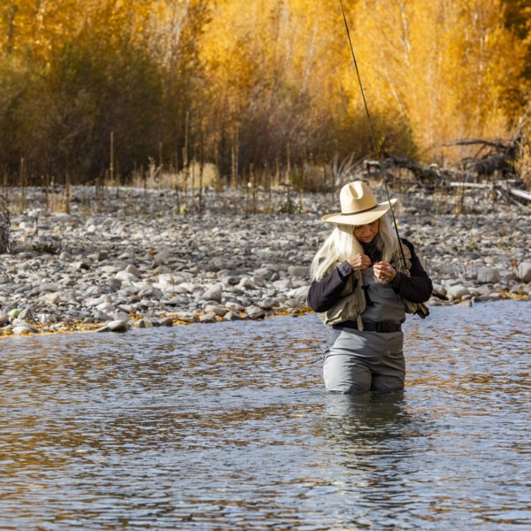 Senior woman fly-fishing