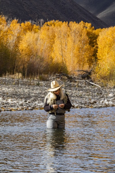 Senior woman fly-fishing