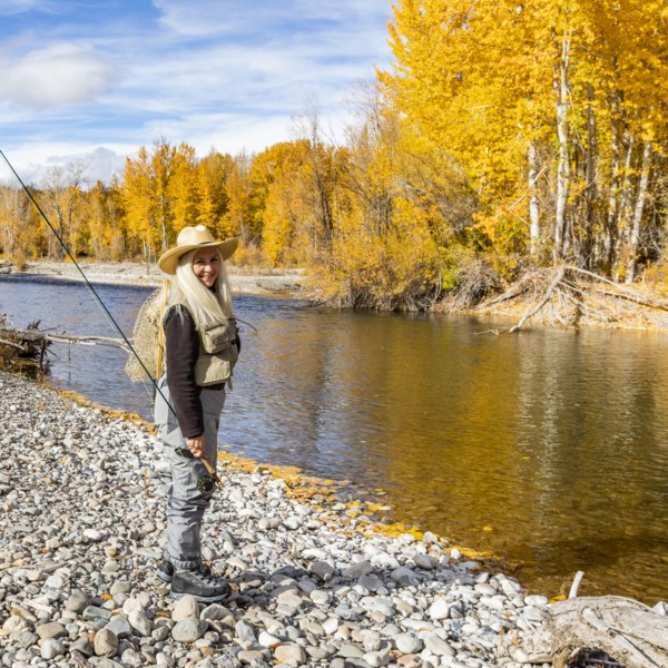 Portrait of senior woman fly-fishing