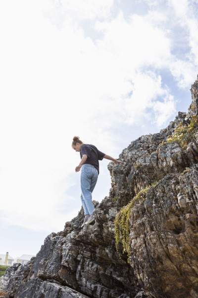 Girl balancing on rock at Grotto Beach
