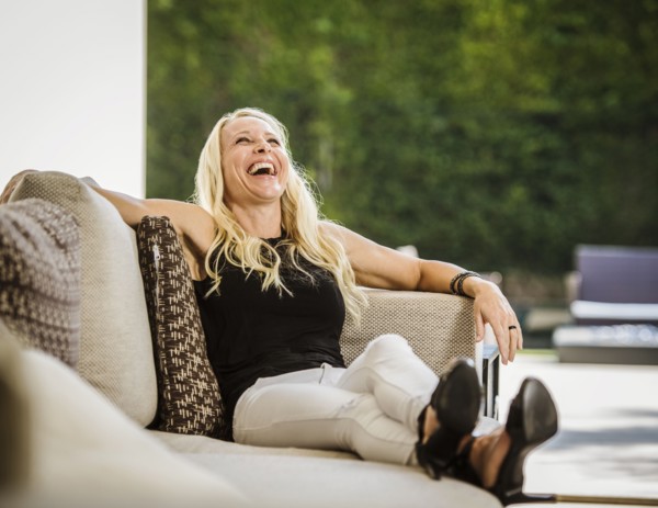 Woman laughing on sofa