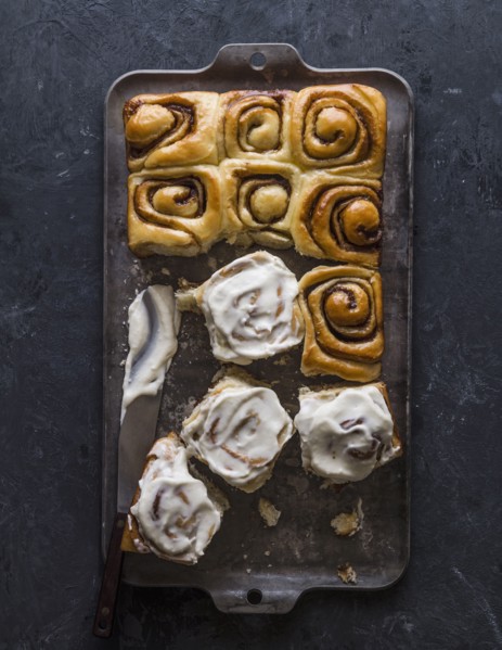 Overhead view of freshly baked cinnamon buns on baking sheet