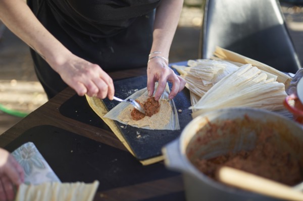 Person preparing tamales, close up