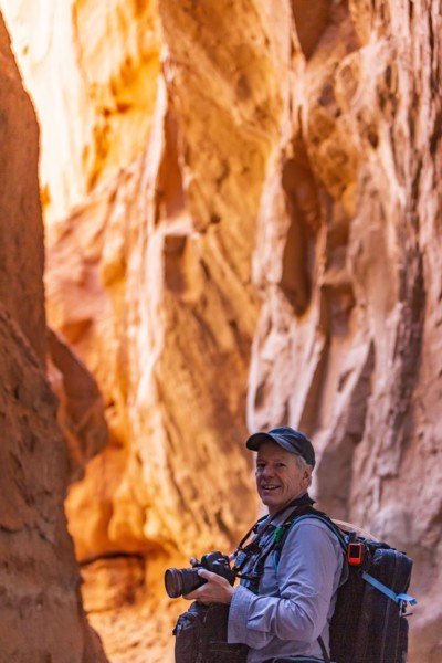 Senior hiker exploring and photographing rock formations in Kodachrome Basin State Park near Escalante Grand Staircase National Monument