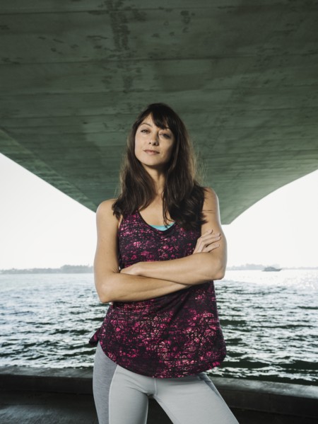 Portrait of woman in sleeveless top under bridge