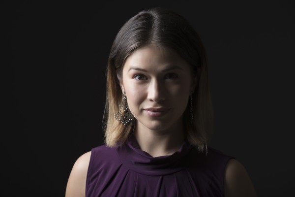 Studio portrait of woman in sleeveless purple top