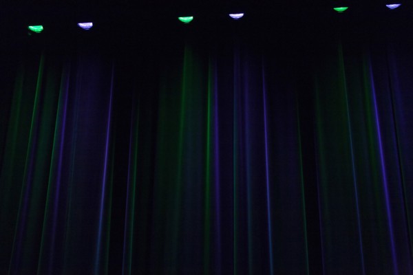 Stage curtain illuminated in green and blue