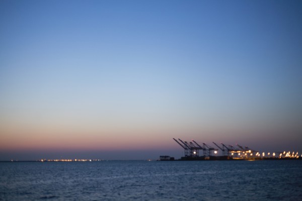 Silhouette of cranes in dock at dusk