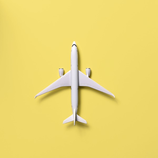 Overhead view of airplane model against yellow background