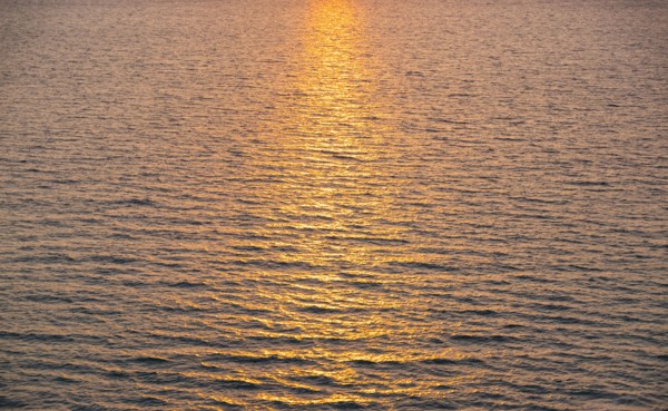 Rippled ocean surface reflecting sunlight