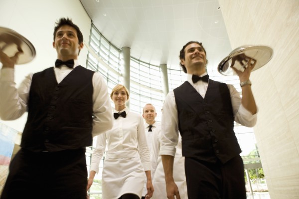 Group of waiters carrying trays
