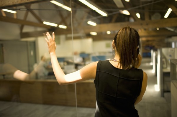 Rear view of woman talking on phone in office