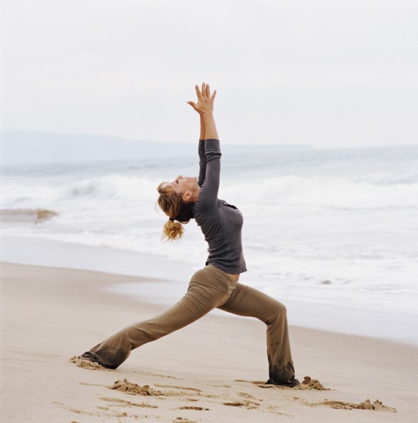 Woman doing yoga on beach