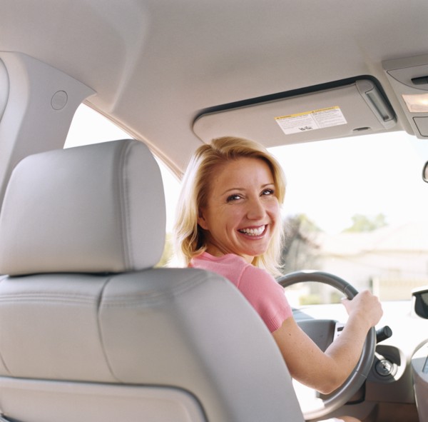 Portrait of woman sitting in drivers seat of car