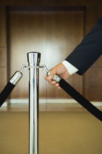 Man holding velvet rope