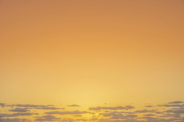 Golden sunrise sky with low clouds