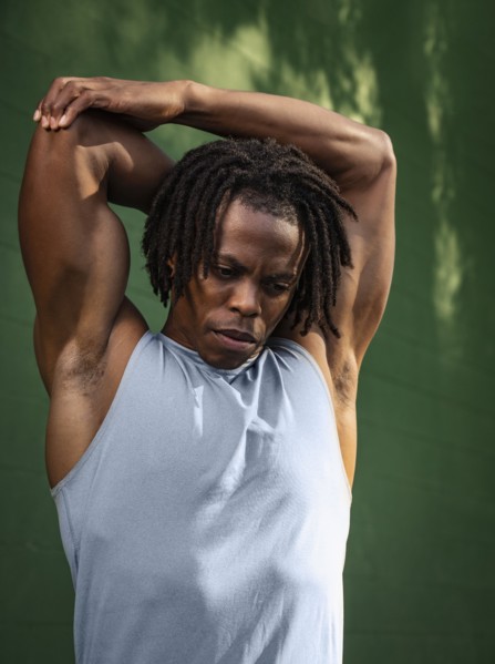 Man stretching arm outdoors