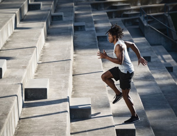 Athletic man running up steps
