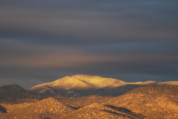 Light snow on Sangre de Cristo Mountains at sunset