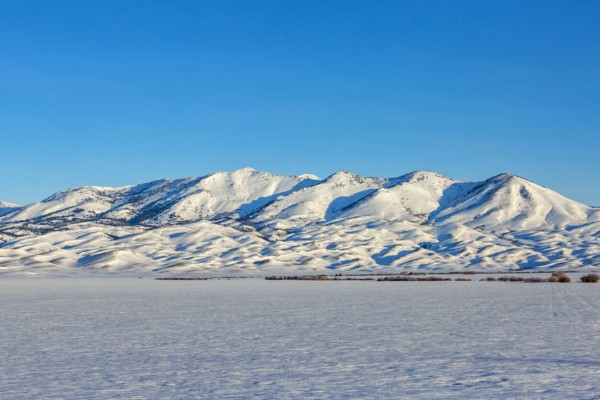 Snow covered field and Soldier Mountain on sunny day