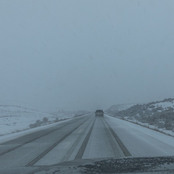 Snow covered rural road seen from car