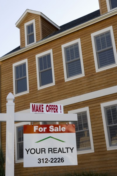 For Sale sign in front of house
