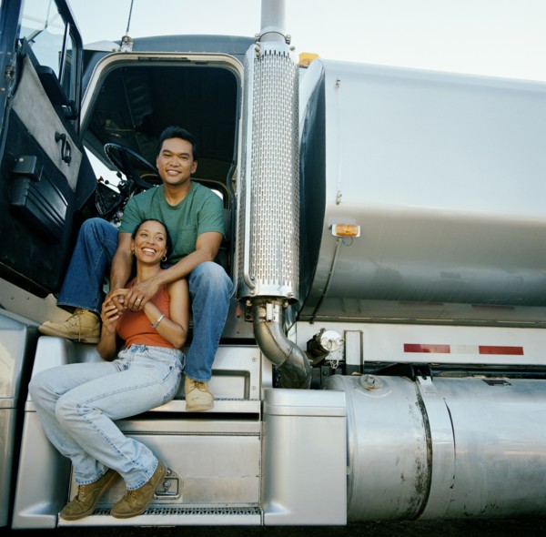 Couple sitting on doorsteps of truck