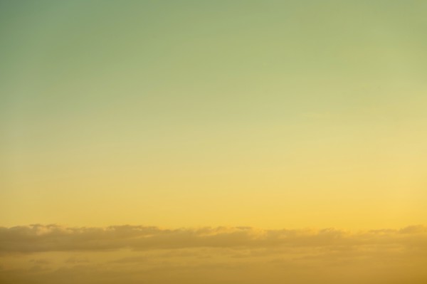 Golden sky at sunrise with low clouds below