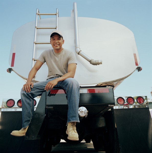 Truck driver sitting on his vehicle