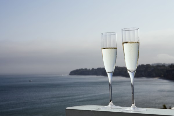 Two glasses of champagne with sea in background