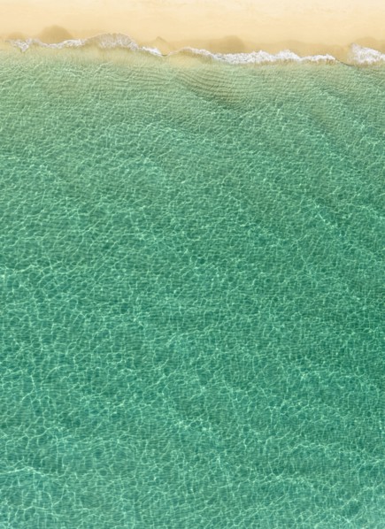 Overhead view of turquoise ocean and beach