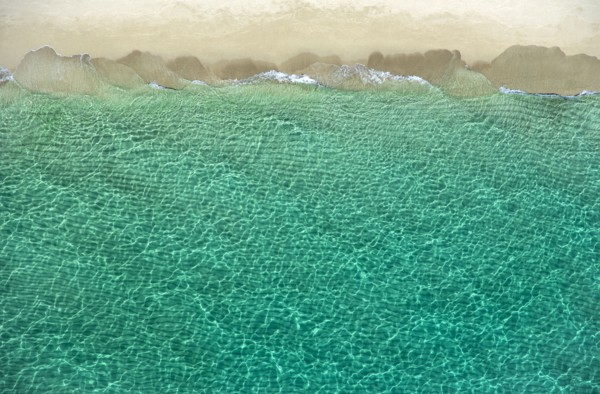 Overhead view of turquoise ocean and beach