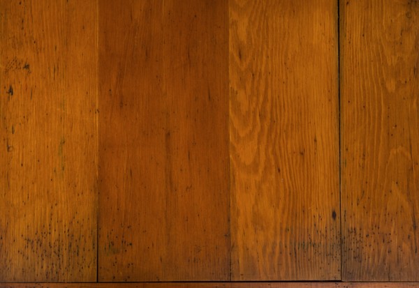 Close-up of worn antique cutting board with knife cut marks