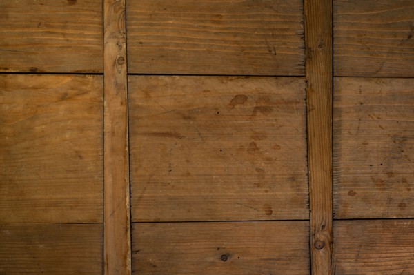 Close-up of worn antique cutting board with cross support wood slats