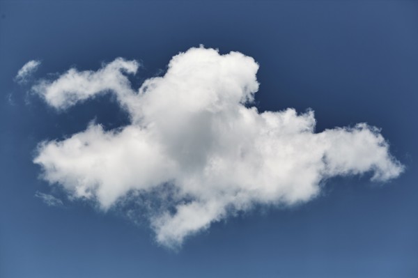 Single white cloud in blue sky