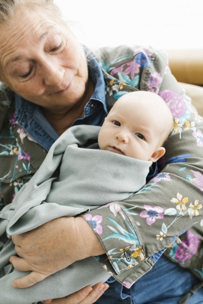 Grandmother holding newborn grandson
