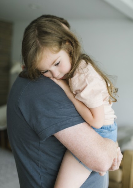 Father holding daughter
