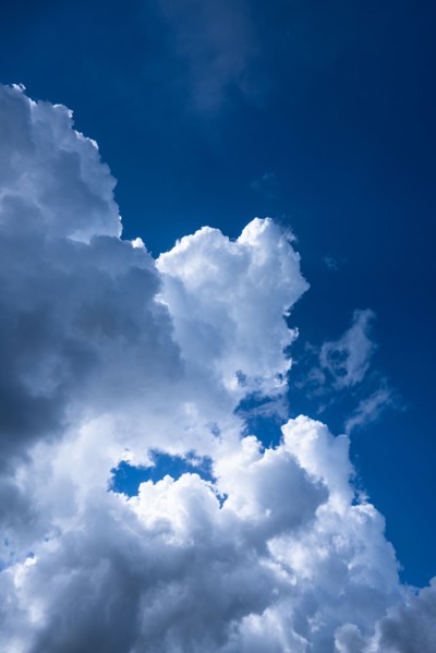 Puffy cumulus clouds against blue sky