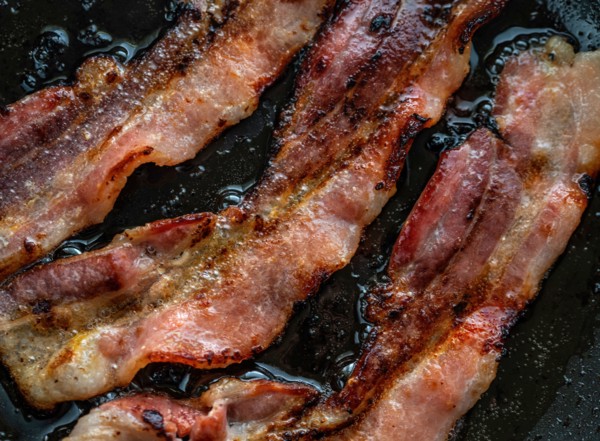 Close-up of bacon slices on frying pan